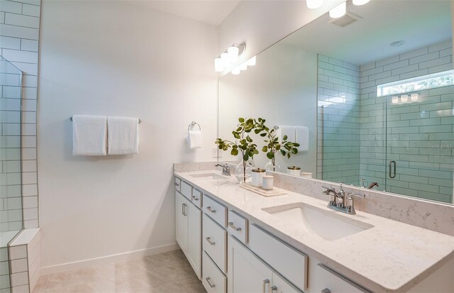 bathroom featuring an enclosed shower, vanity, and tile patterned floors