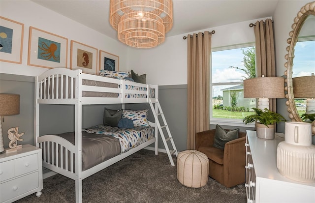 carpeted bedroom featuring a chandelier