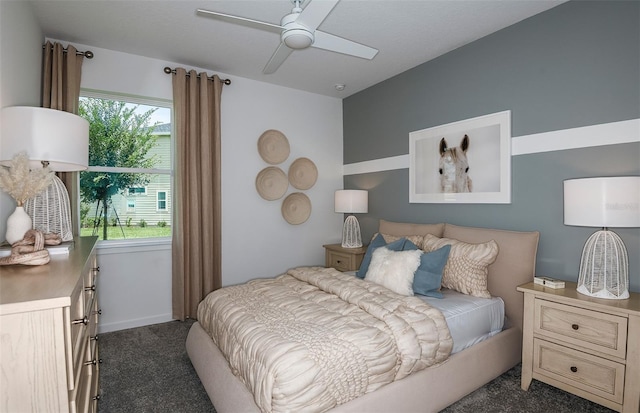 bedroom with ceiling fan and dark carpet