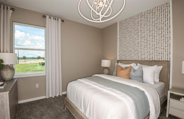 bedroom featuring multiple windows, dark carpet, and a notable chandelier