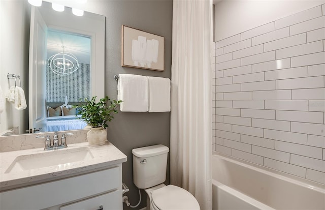 full bathroom featuring vanity, toilet, a notable chandelier, and shower / bathtub combination with curtain