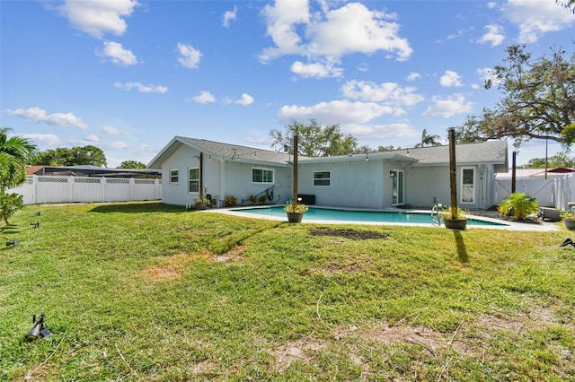 rear view of house with a yard