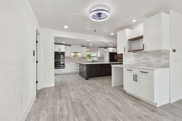 kitchen with pendant lighting, white cabinetry, and a kitchen island