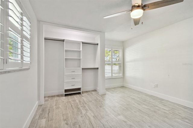 unfurnished bedroom featuring ceiling fan, a closet, and light wood-type flooring