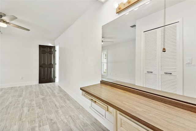 hallway with light hardwood / wood-style floors