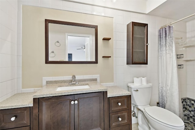 bathroom featuring vanity, toilet, and walk in shower