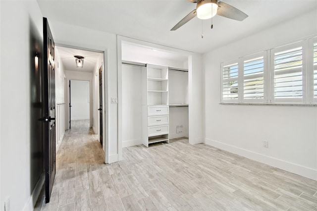 unfurnished bedroom featuring ceiling fan, a closet, and light hardwood / wood-style floors