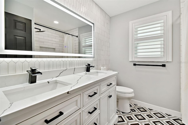 bathroom with curtained shower, tile patterned flooring, vanity, and toilet