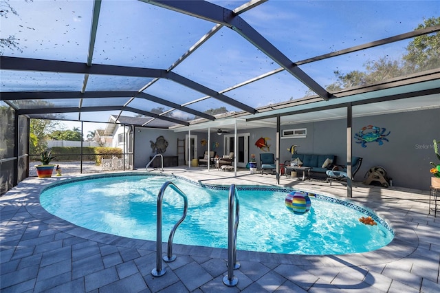 view of swimming pool with glass enclosure and a patio area