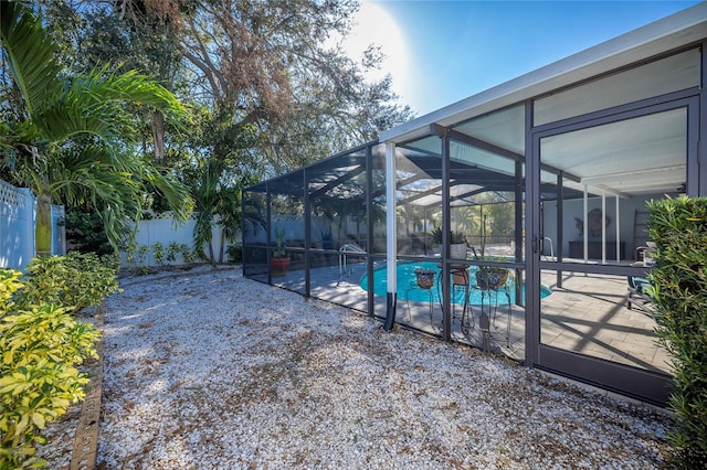 view of swimming pool featuring a patio area and a lanai