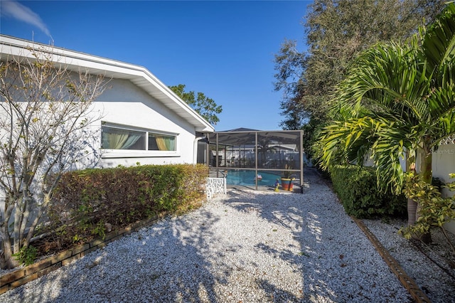 view of property exterior featuring a lanai and a patio area