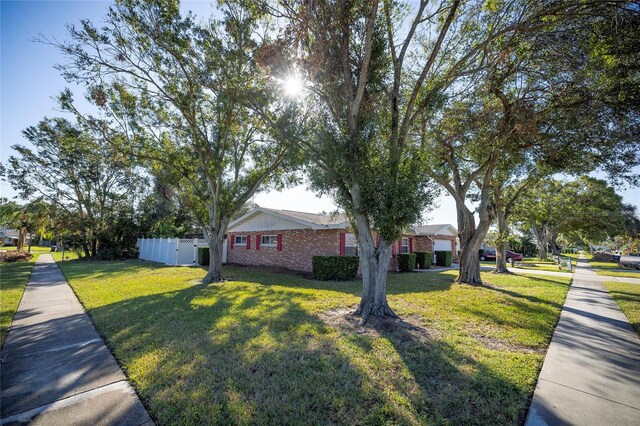 ranch-style home with a front lawn