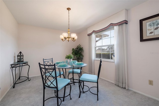 carpeted dining space with a chandelier