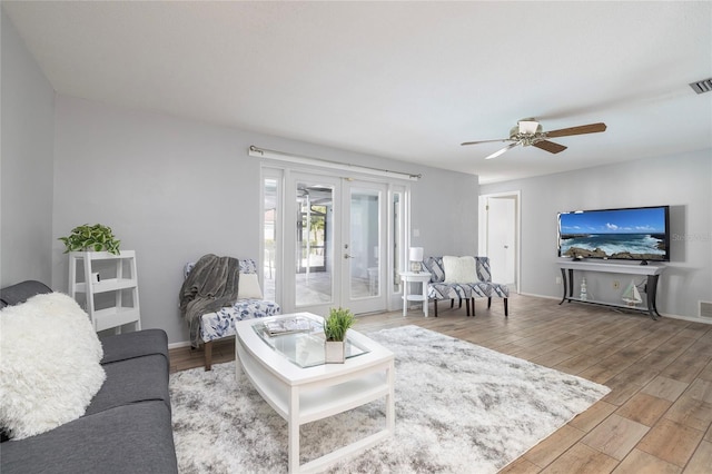 living room with ceiling fan and french doors