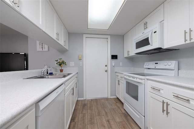 kitchen featuring sink, white appliances, white cabinetry, and light hardwood / wood-style flooring