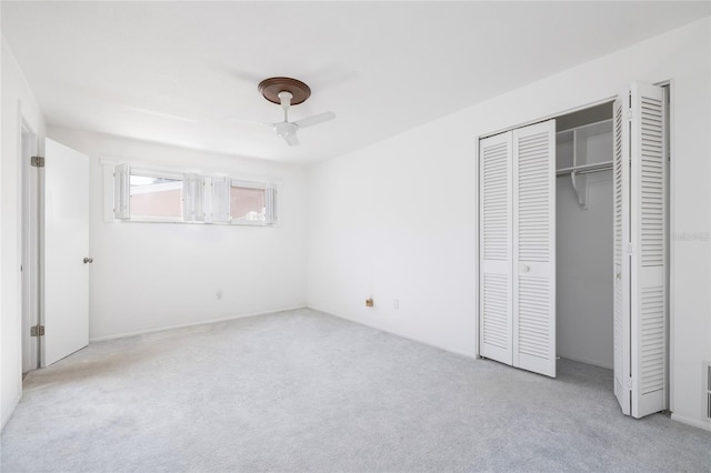 unfurnished bedroom with ceiling fan and light colored carpet