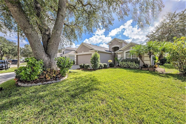 view of front of house featuring a garage and a front lawn