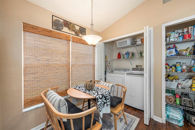 dining area featuring washer and dryer, lofted ceiling, and dark hardwood / wood-style floors