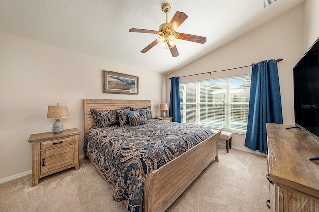 carpeted bedroom with ceiling fan and vaulted ceiling