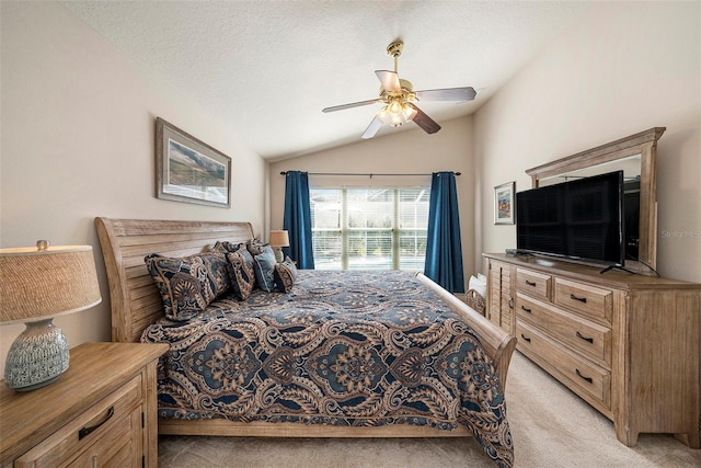 bedroom with ceiling fan, light carpet, a textured ceiling, and lofted ceiling