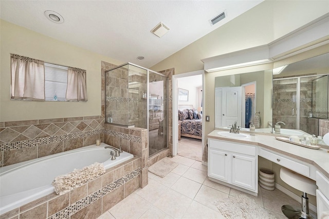 bathroom with vanity, vaulted ceiling, and separate shower and tub