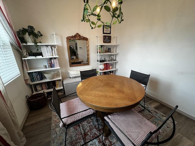 dining space featuring dark hardwood / wood-style floors, an inviting chandelier, and a healthy amount of sunlight