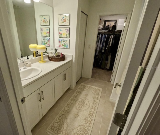 bathroom featuring tile patterned flooring and vanity