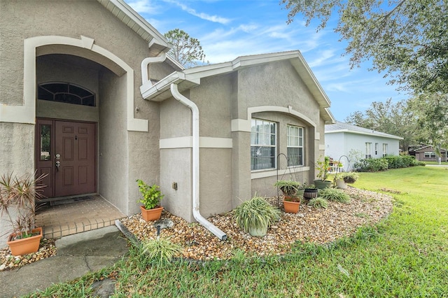 doorway to property with a yard