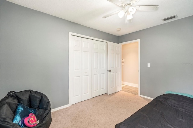 carpeted bedroom with a closet and ceiling fan