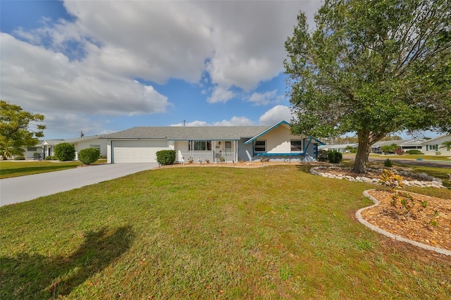 ranch-style house with covered porch, a front yard, and a garage