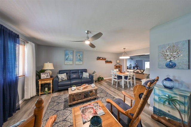 living room with wood-type flooring and ceiling fan