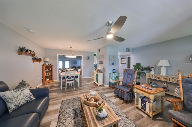 living room featuring ceiling fan and wood-type flooring