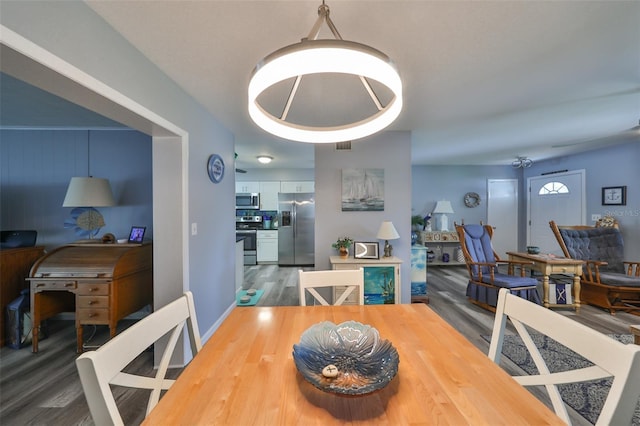 dining space with dark hardwood / wood-style floors