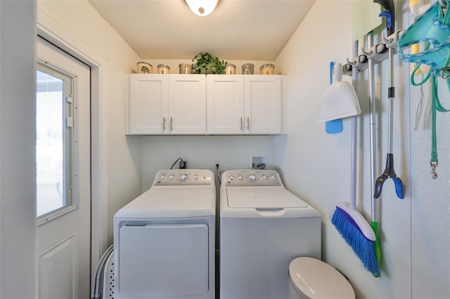 laundry area featuring washing machine and dryer and cabinets