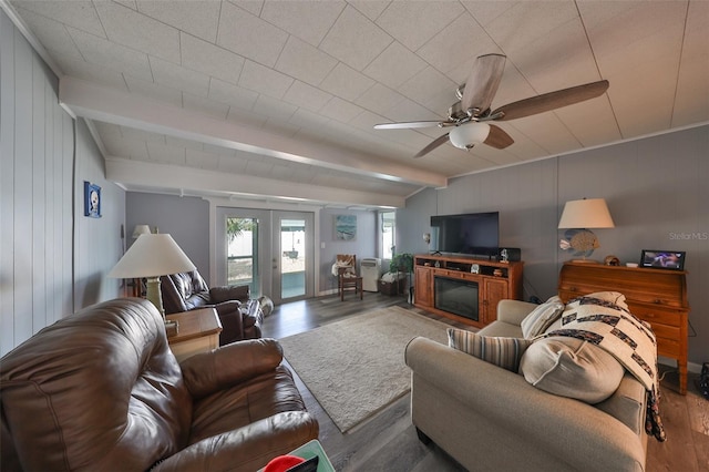 living room with french doors, ceiling fan, beamed ceiling, and dark hardwood / wood-style floors