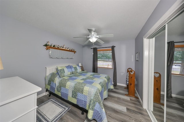 bedroom featuring hardwood / wood-style floors, a closet, and ceiling fan