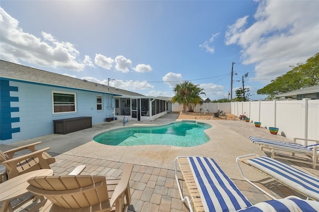 view of pool featuring a patio and a sunroom