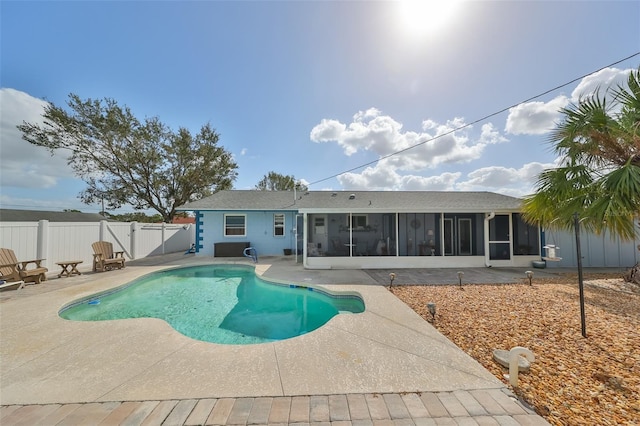 view of swimming pool featuring a sunroom and a patio area