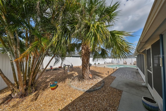 view of yard featuring a fenced in pool and a patio area