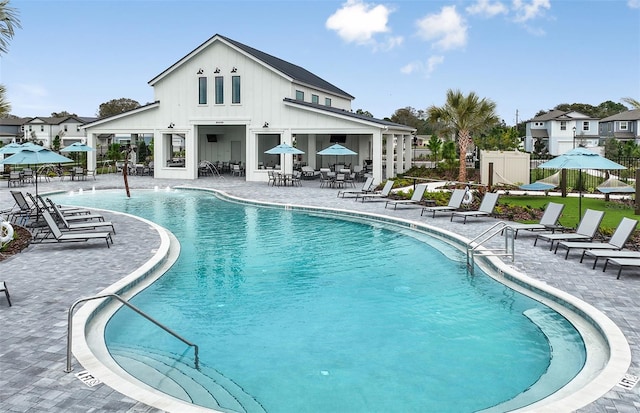 pool with fence and a patio