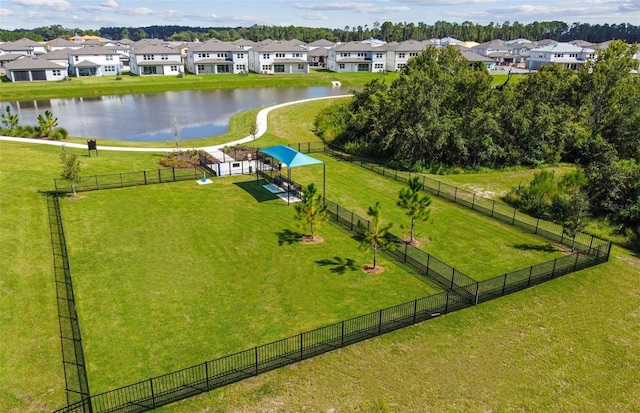 birds eye view of property with a water view and a residential view