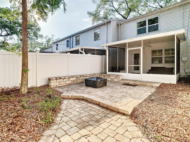 rear view of property with a sunroom and a patio