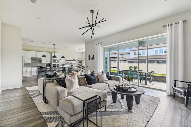 living room with dark hardwood / wood-style floors and a chandelier