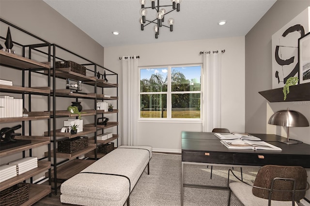 office space featuring a textured ceiling, an inviting chandelier, and hardwood / wood-style floors