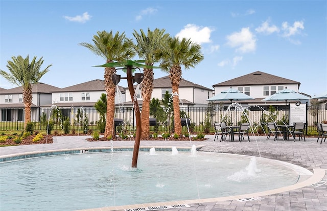 view of swimming pool with a patio area and pool water feature