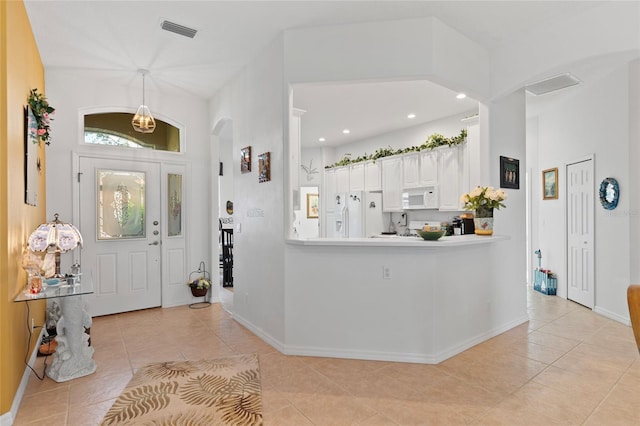 foyer entrance with light tile patterned floors