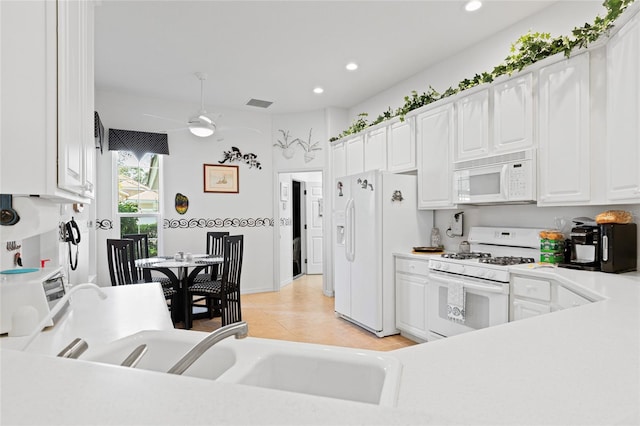 kitchen with white cabinetry, ceiling fan, light tile patterned floors, and white appliances