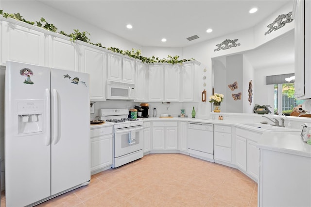 kitchen with sink, white cabinets, white appliances, and light tile patterned flooring