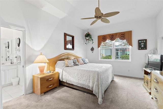 carpeted bedroom featuring ensuite bath and ceiling fan