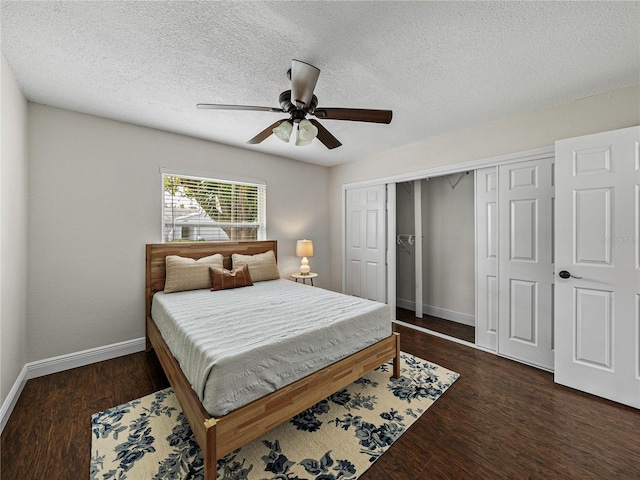 bedroom featuring dark wood-type flooring, a closet, a textured ceiling, and ceiling fan